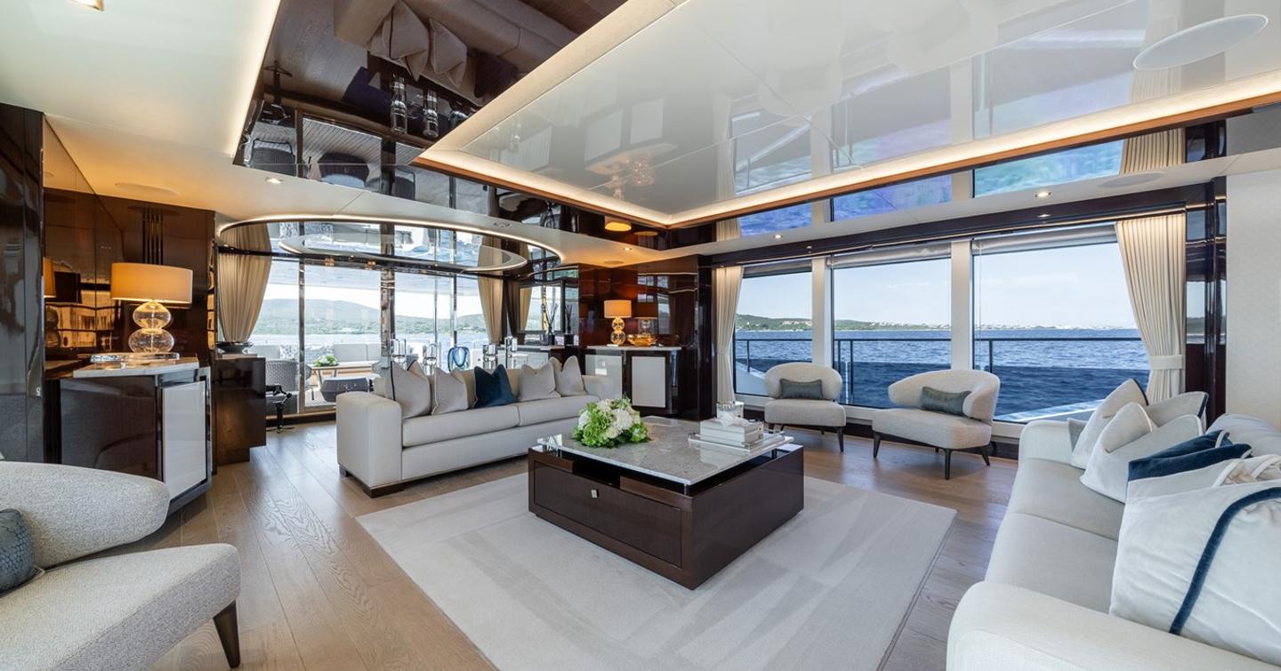 Superyacht Berco Voyager main saloon with white furniture and ceiling LED