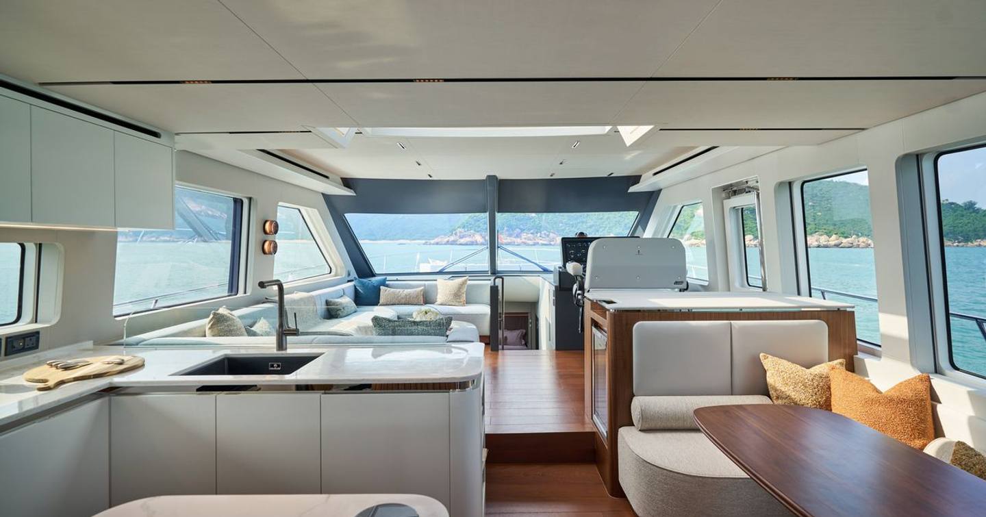 CL Yachts CLB65 SUV Motor Yacht main salon with wooden finishes and L-shaped galley