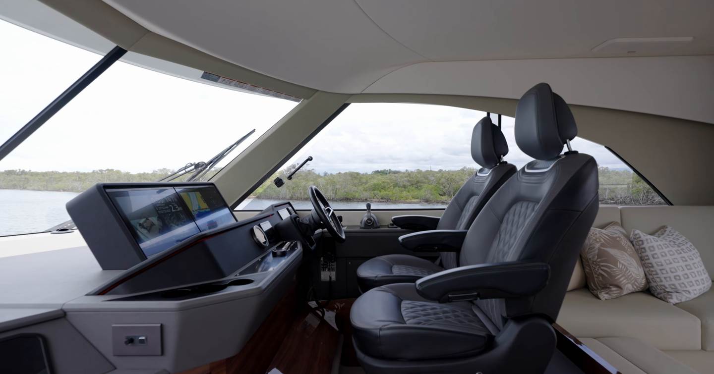 Maritimo M50 enclosed flybridge helm with twin seats, dashboard and panoramic forward visibility