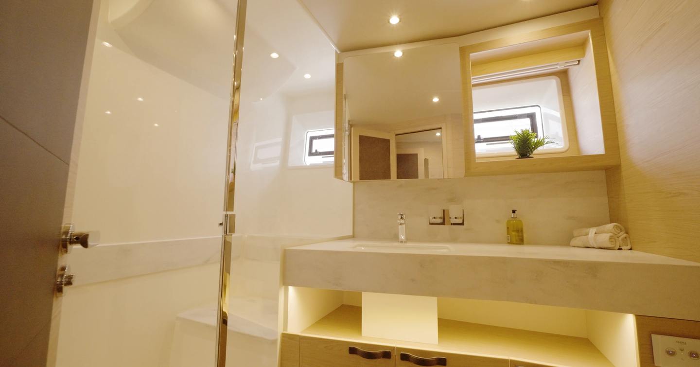 Beneteau Grand Trawler 63 owner's en suite with walk-in shower, Corian vanity and generous storage