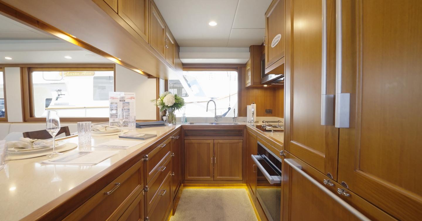 Fleming 85 country-style galley with large island, full-size appliances and panoramic windows