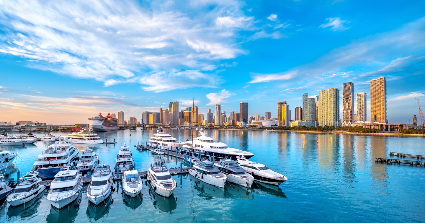 Marina with berthed motor yachts with Miami skyline in background