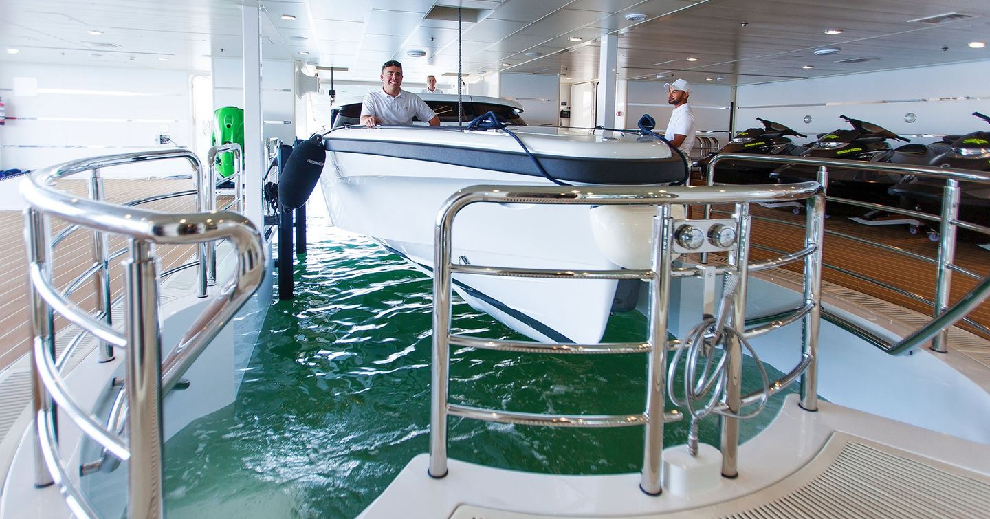 Tender being lowered into water in Superyacht I Dynasty within floodable tender garage