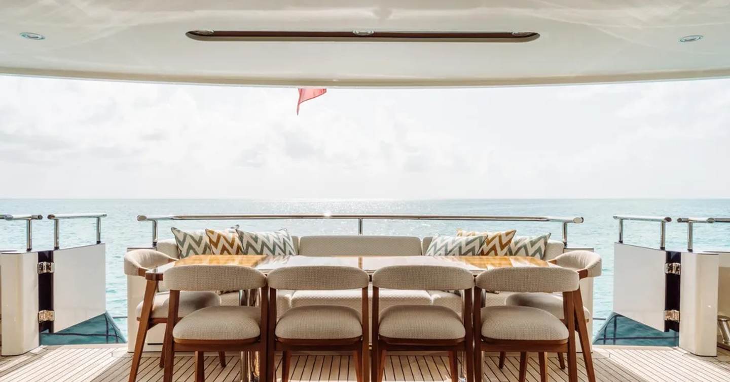 Superyacht Mustique's main deck aft shaded dining area