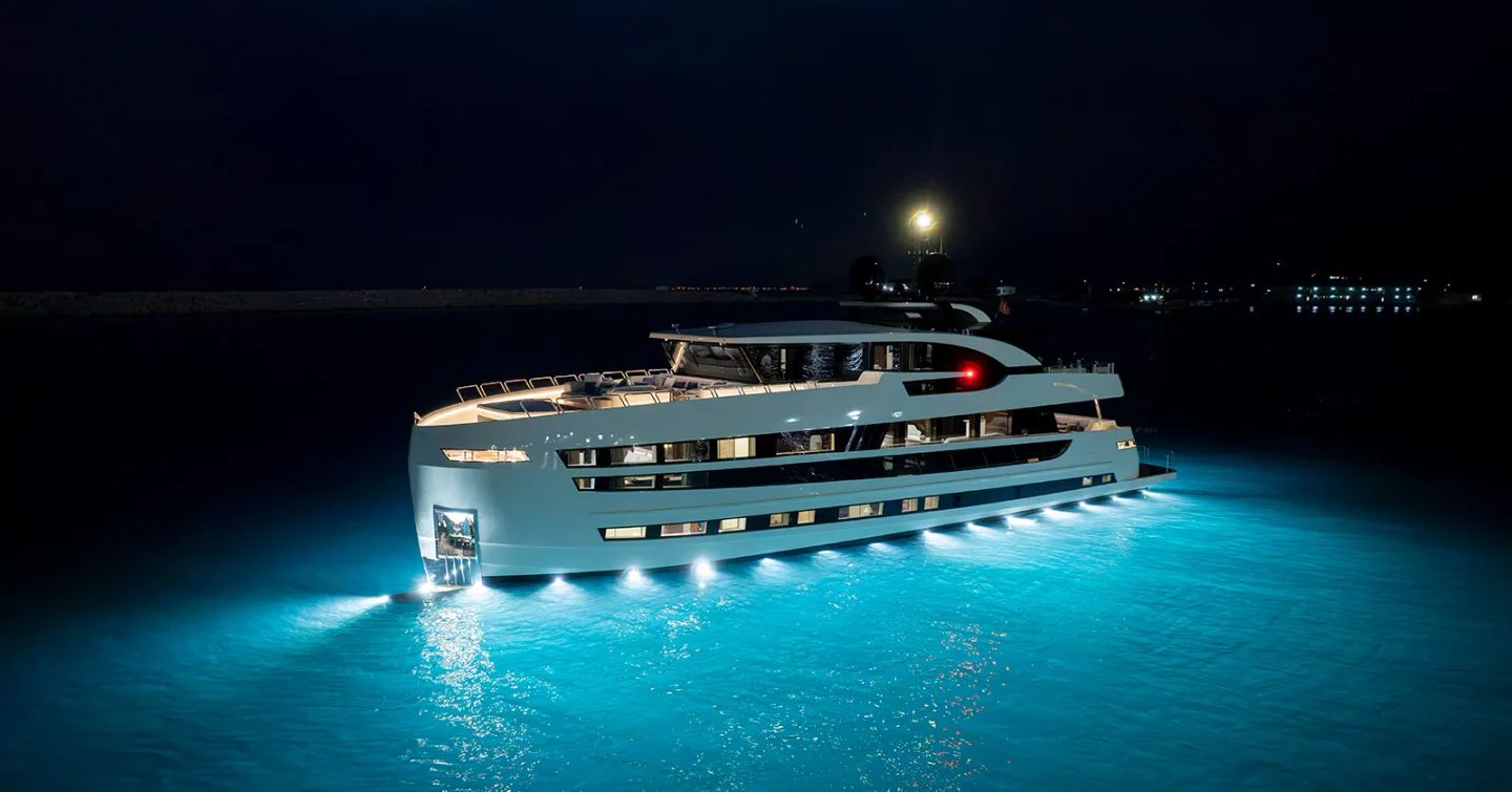 Lazzara UHV 100 Motor Yacht at night with underwater lights