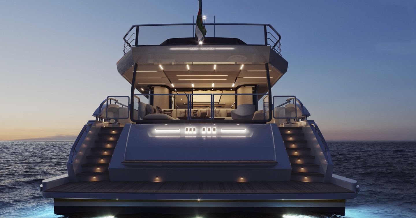 Aft view of Majesty 111 at dusk, swim platform with steps either side leading up to main deck.