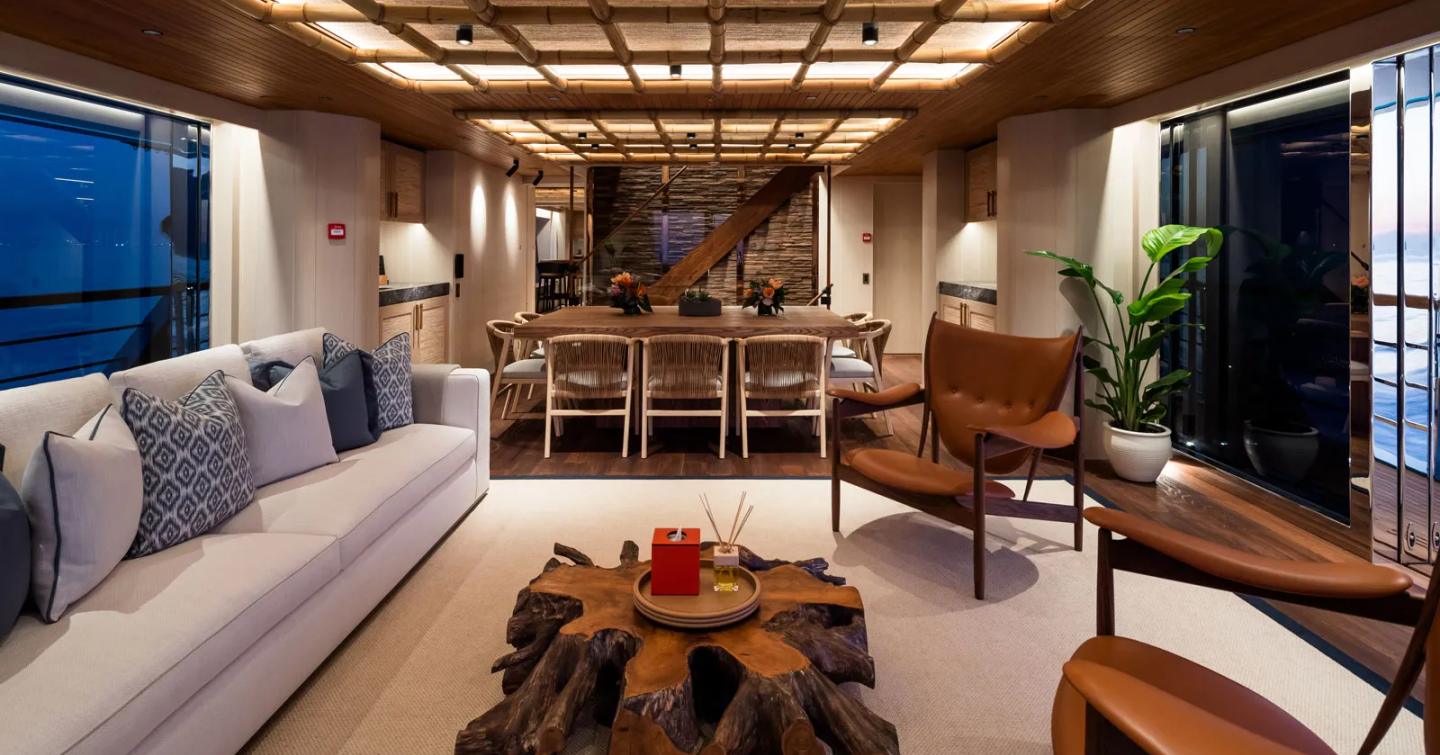 Expedition Yacht King Benji interior with tropical theme and wooden dining table 