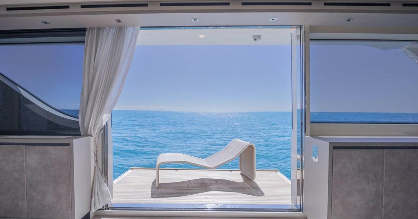 Swim platform on motor yacht Phoenix with sunbed and calm sea in the background