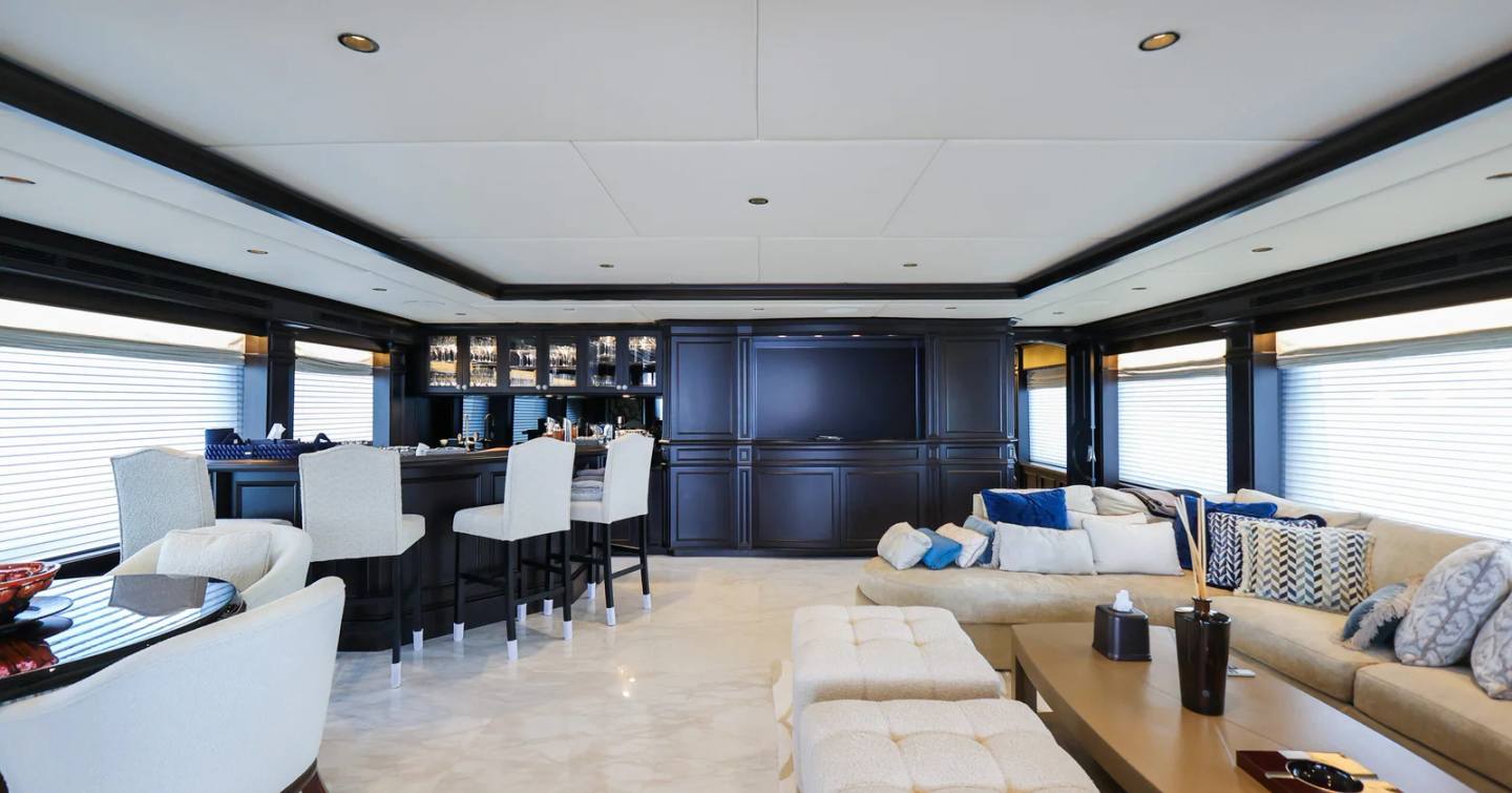 Trinity superyacht Mirabella interior post-refit with integrated bar area and white L-shaped sofa 