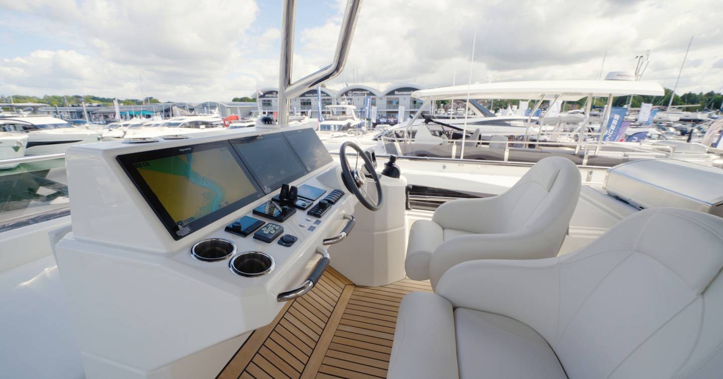 Beneteau Grand Trawler 63 flybridge helm with twin Garmin displays and commanding elevated driving position