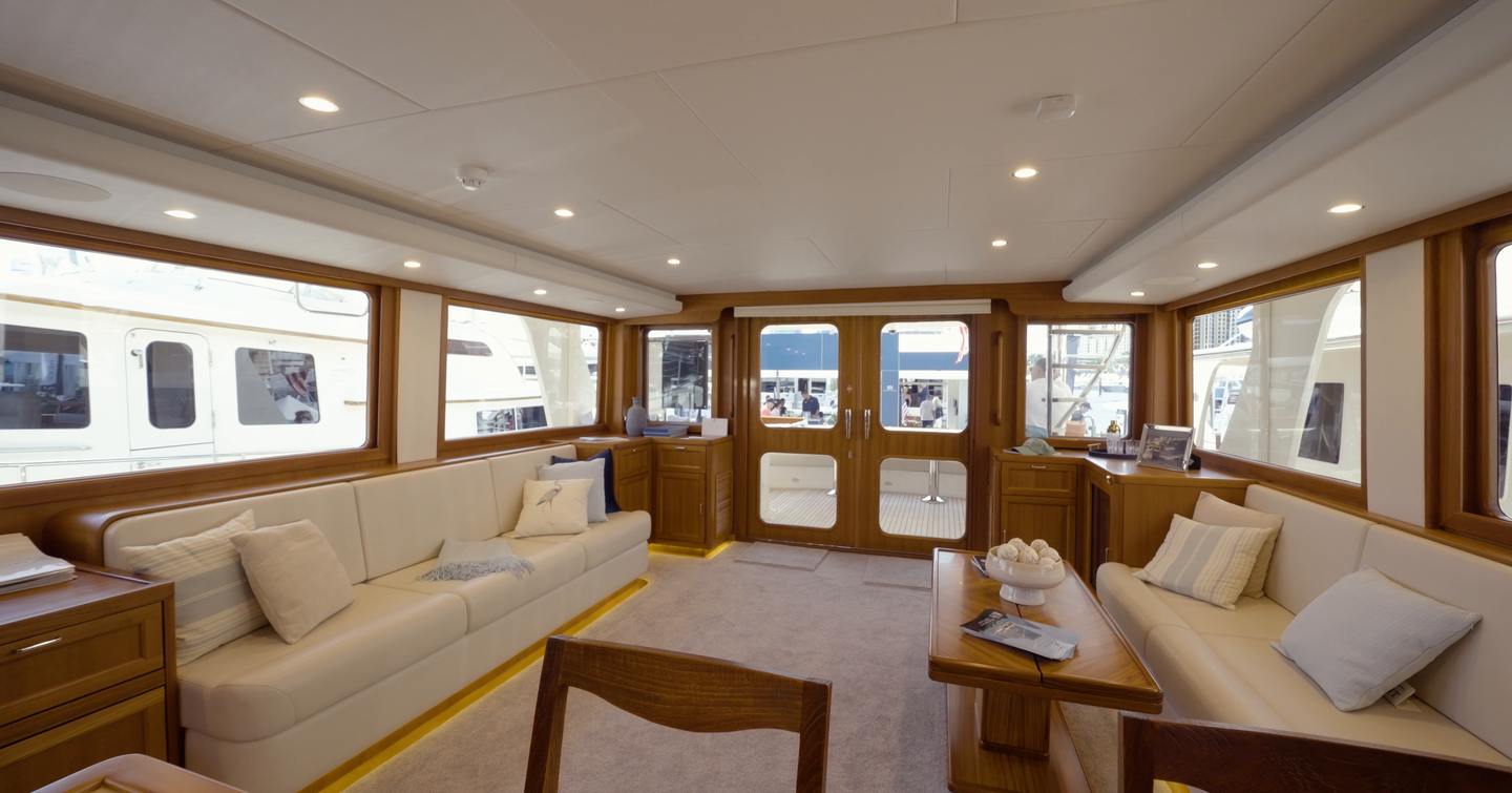 Fleming 85 main saloon with panoramic windows, twin sofas and aft cockpit access