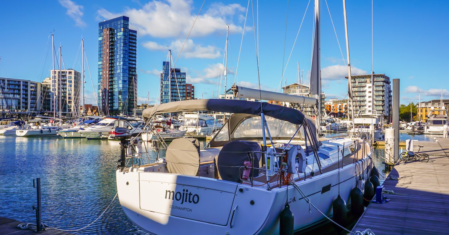 Motor boat named MOJITO moored in Ocean Village Marina, Southampton. Other boats moored in background.