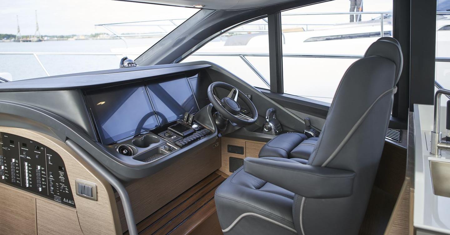 Princess V55 helm station with twin displays, dished steering wheel and twin shaft-drive controls