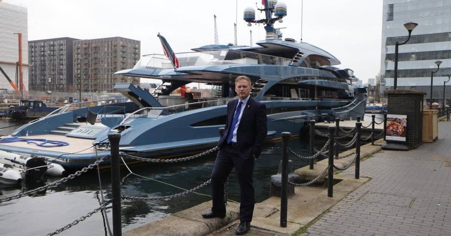 Grant Shapps standing in fron of Superyacht Phi