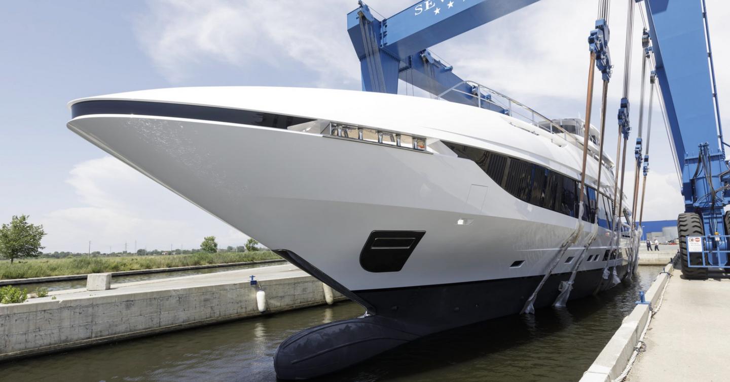 Front view of Mangusta Oceano 50 bow being lowered into the water in Pisa Navicelli