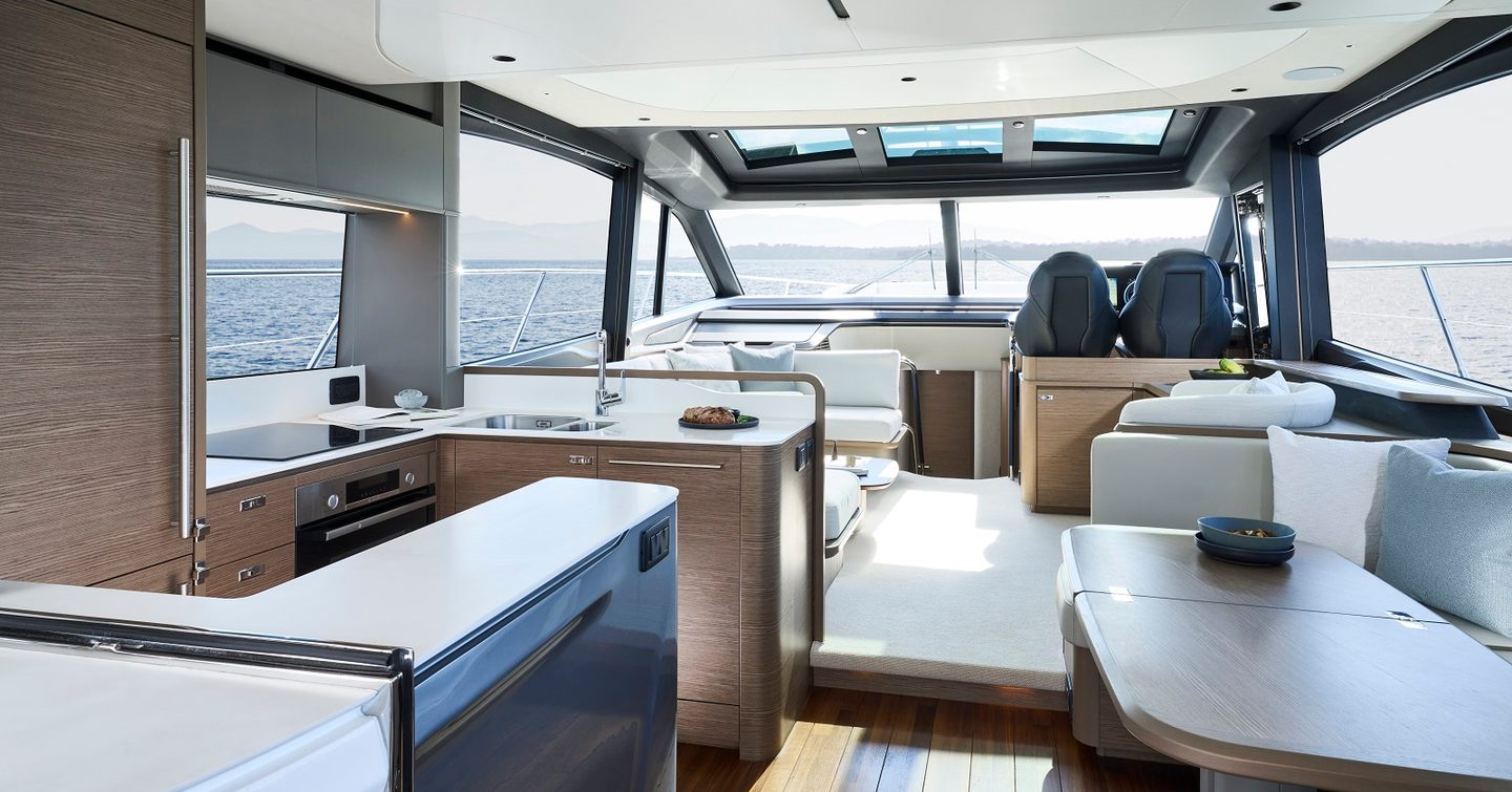 Princess S65 motor yacht's interior with galley, seating and helm station