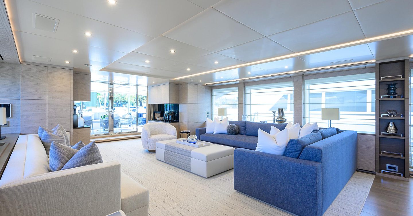 Superyacht Cofina's main saloon with L-shaped sofas