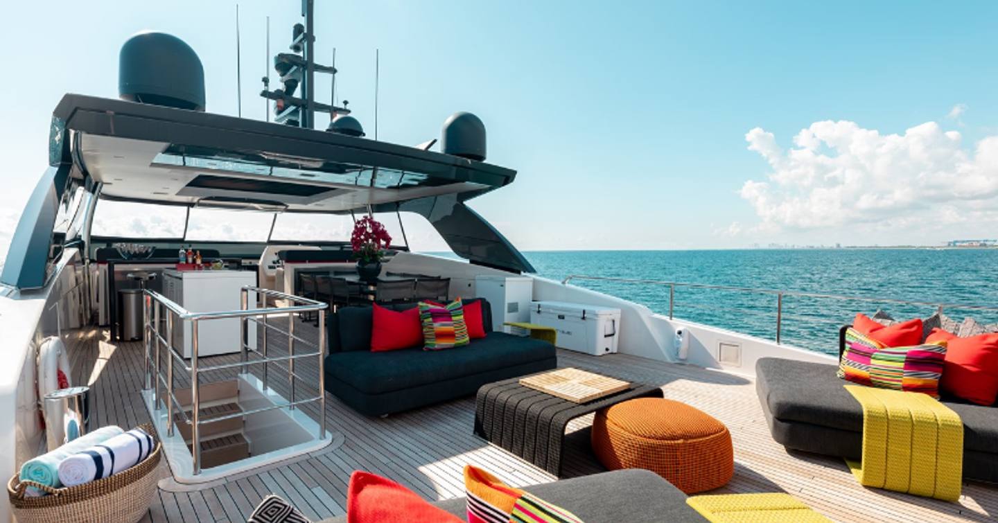 Motor yacht Fifty Shades flybridge with colourful furnishings, a seating area and a bar