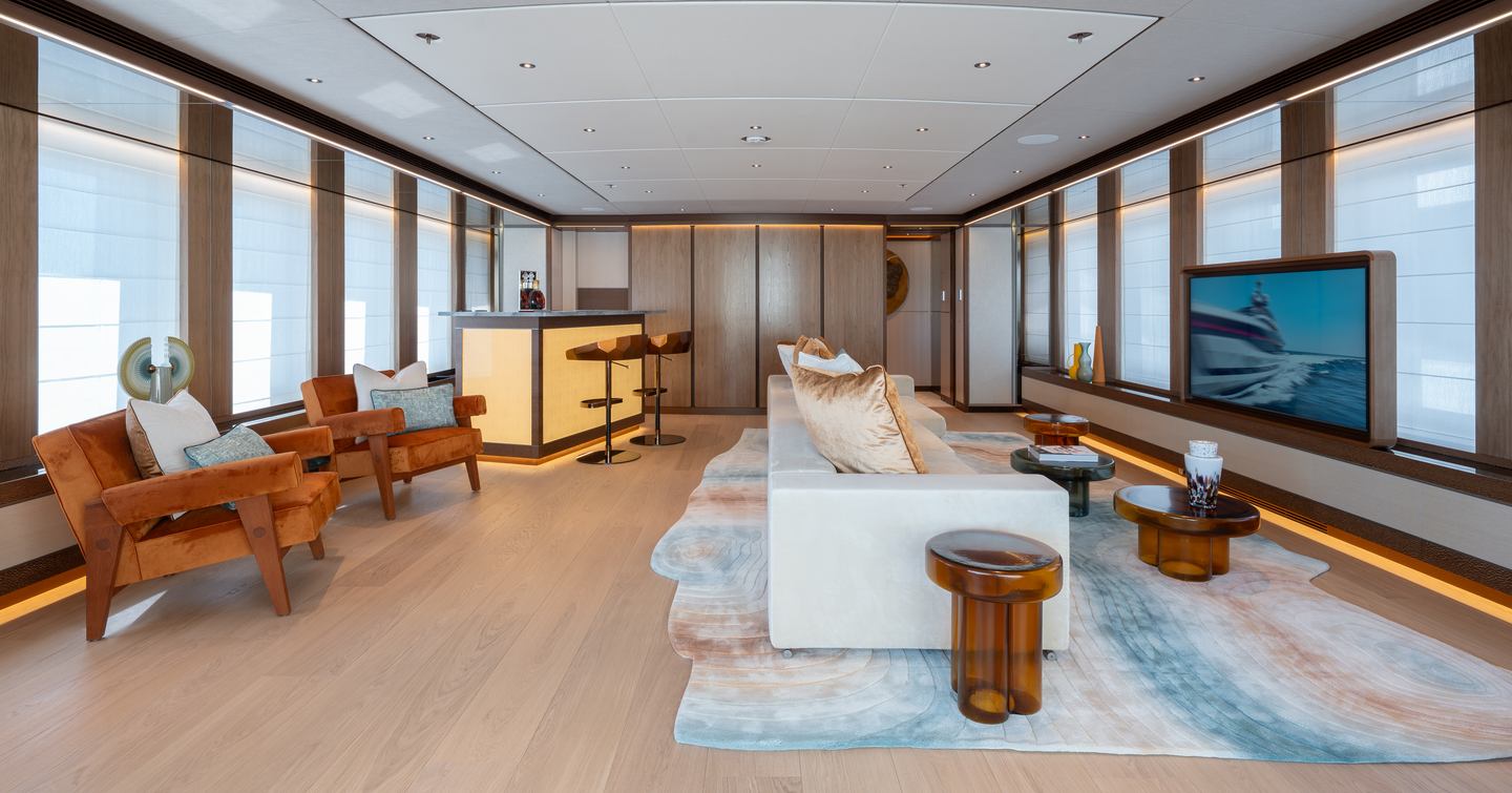 Superyacht Agnetha saloon with mounted TV and minimalist bar area