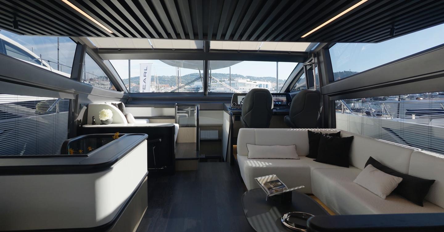 Pearl 73 forward saloon seating beside the lower helm