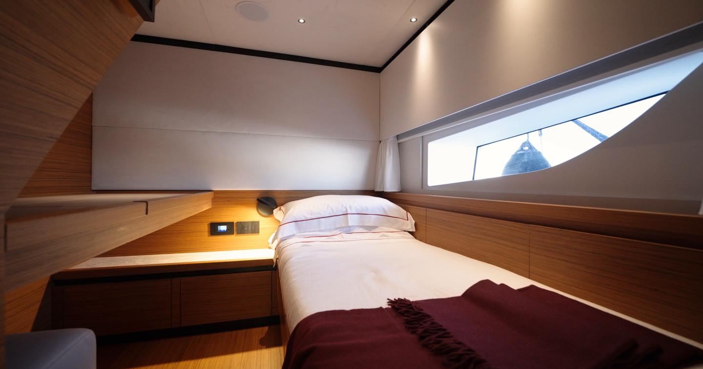 Solaris-Power-60-Coupe-Review-guest-cabin-with-side-window-and-storage