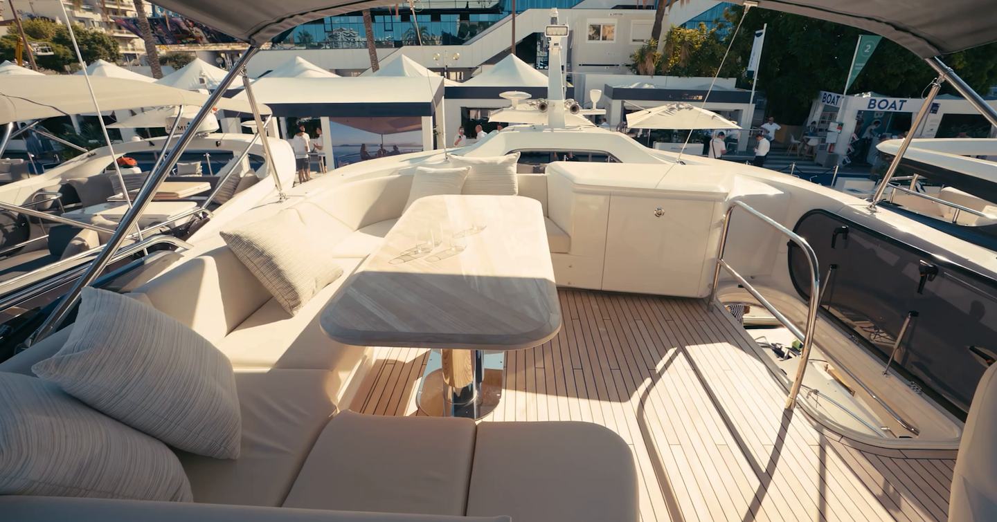 Princess S65 Mk2 sportsbridge with U-shaped seating, dining table and hydraulic bimini