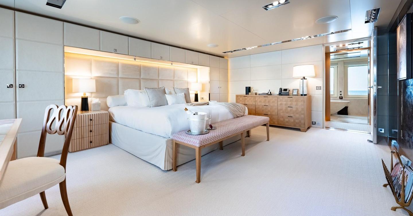 Owner's cabin with king sized bed, wooden chest of drawers and ensuite 