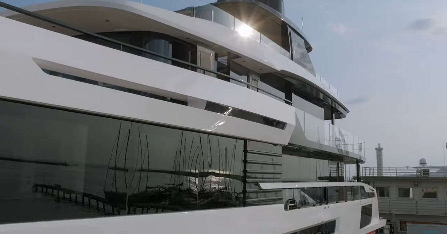 Side view of the superstructure of the Oceano 39, wide stretch of glazing with sun beaming off.