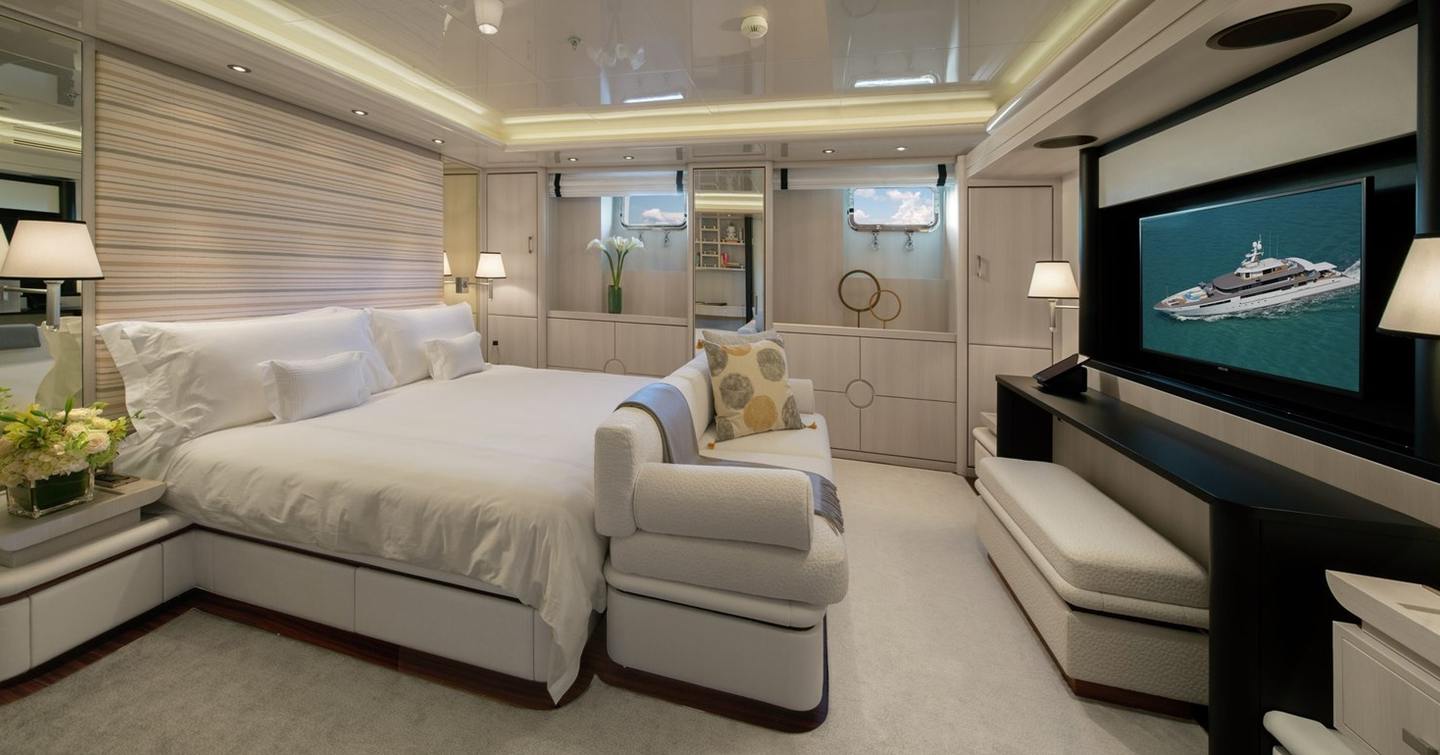 Superyacht Eternity's bedroom with sofa facing mounted TV