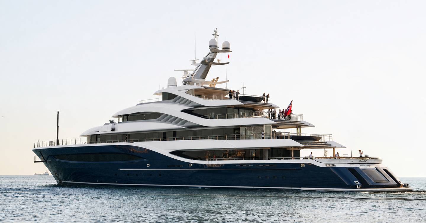 Turquoise superyacht Angelique at anchor stern view 