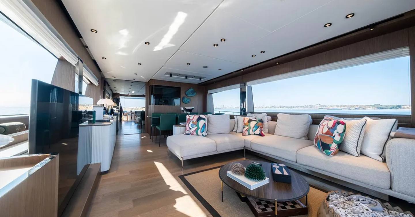 Motor yacht Dogu's main saloon with L-shaped sofa and TV