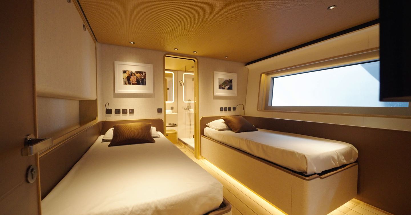 Custom Line Navetta 38 twin guest cabin with two single beds, large window and ensuite bathroom access