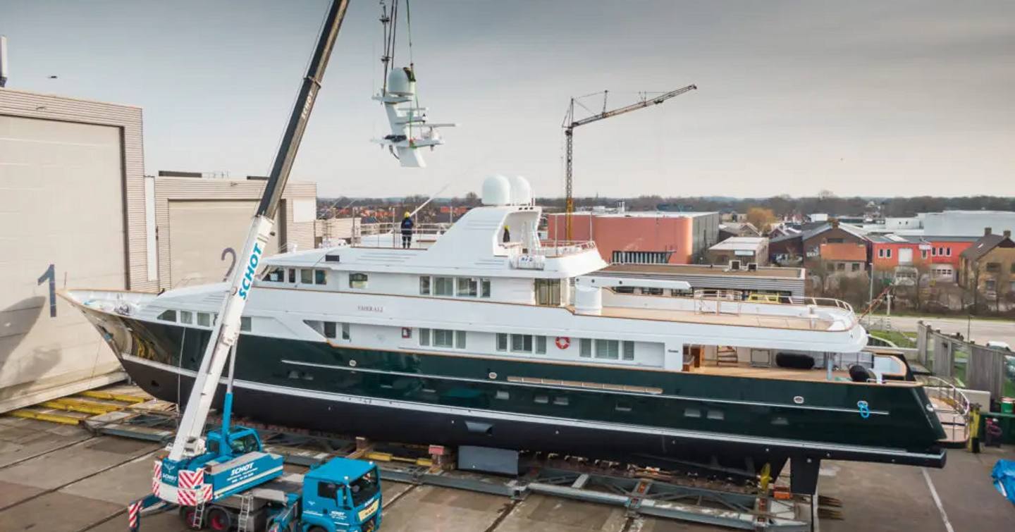 Superyacht EMERALD outside refit shed, awaiting crane to be lowered.