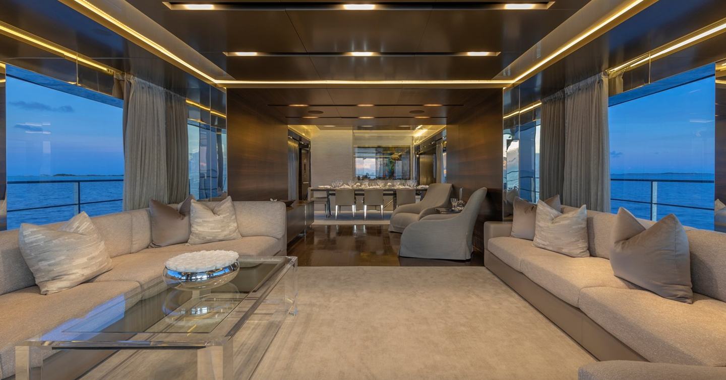 Superyacht Safe Haven main saloon with neutral furniture and large L-shaped sofas 
