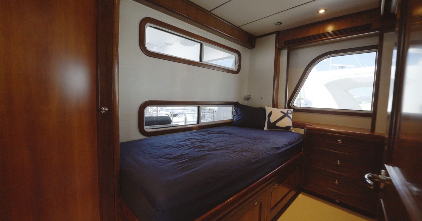 Nordhavn 75 EYF captain's cabin beside the raised pilothouse with single berth and built-in storage