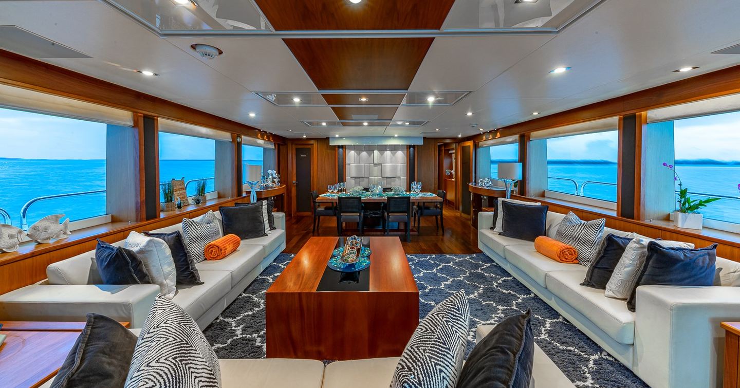 Superyacht Emrys main saloon with white furniture ang wooden coffee table
