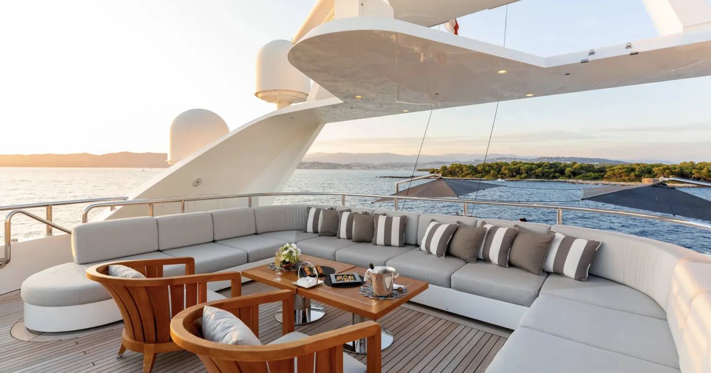 Superyacht Seanna's sundeck with U-shaped seating and alfresco dining