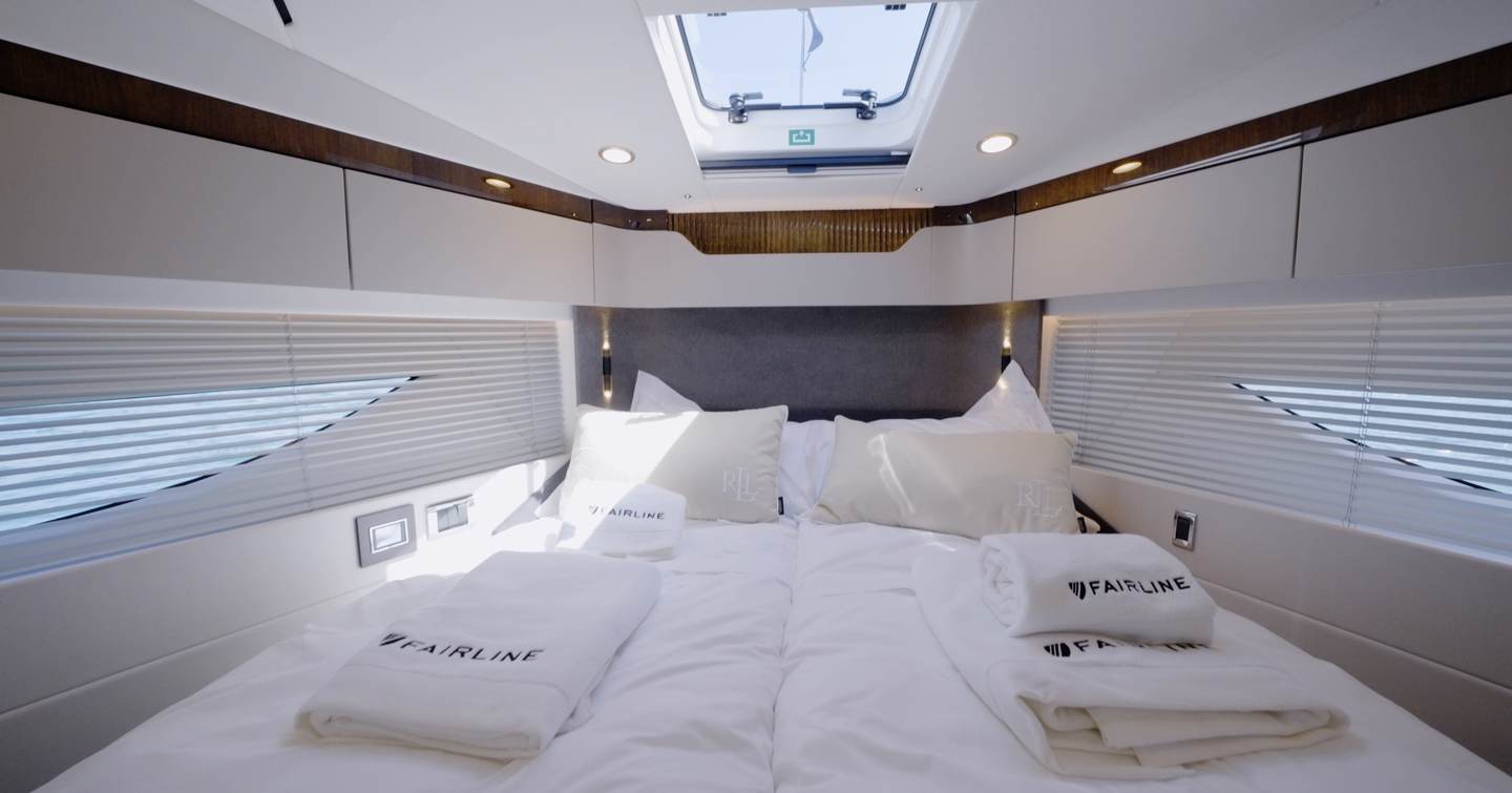 Forward guest cabin on the Fairline Targa 47 GT with sliding scissor berths and overhead hatch