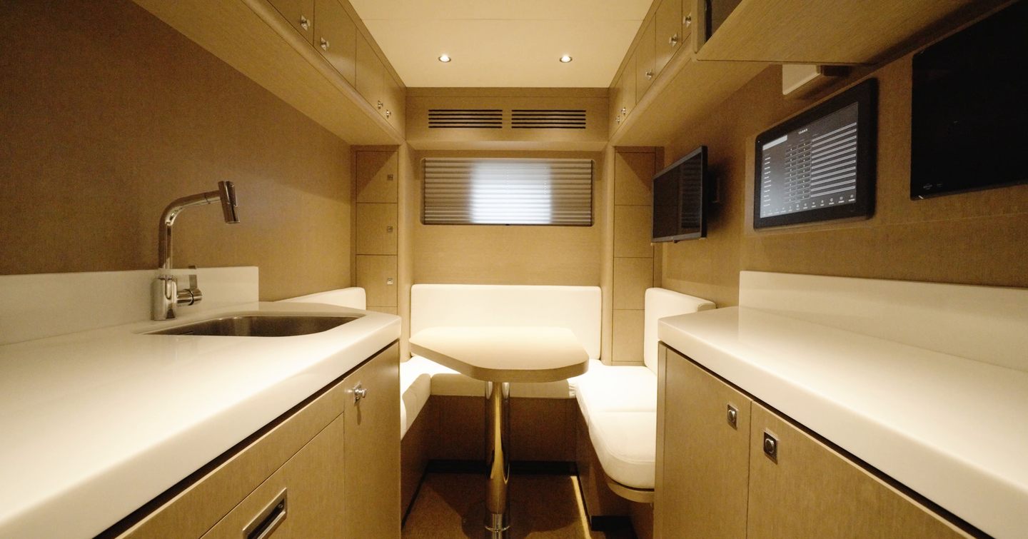 Sirena 118 crew mess with galley, seating and monitoring screens