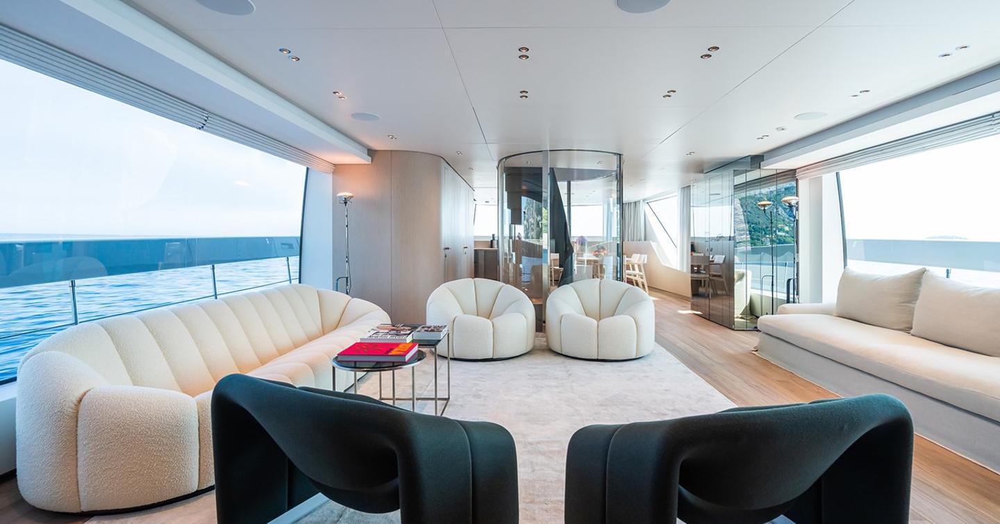 Superyacht Ami's main saloon with seating and coffee table 