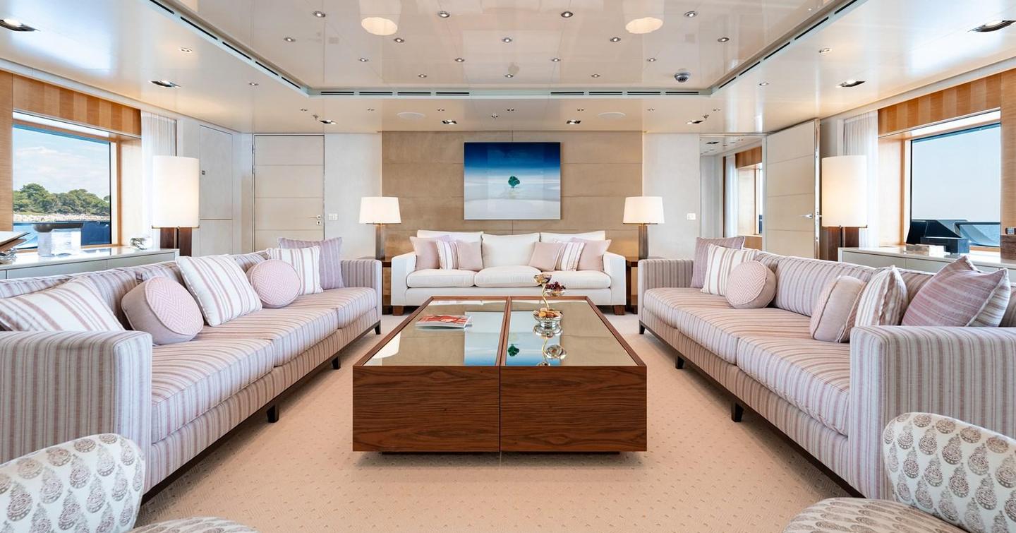 Main saloon on motor yacht Loon, with mixed cream furnishings and pink detailling