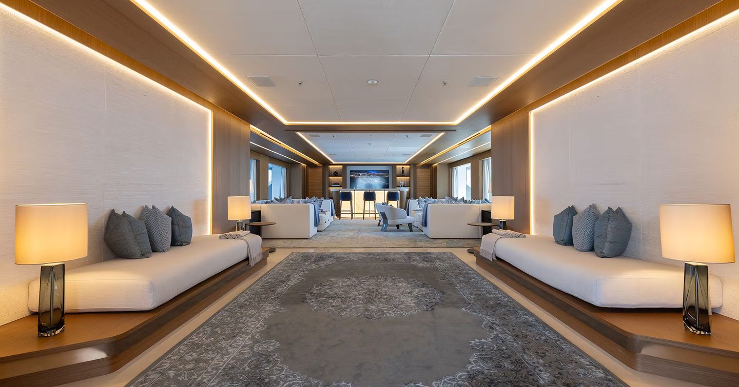 Superyacht Afla saloon post-refit with bar area and white furniture