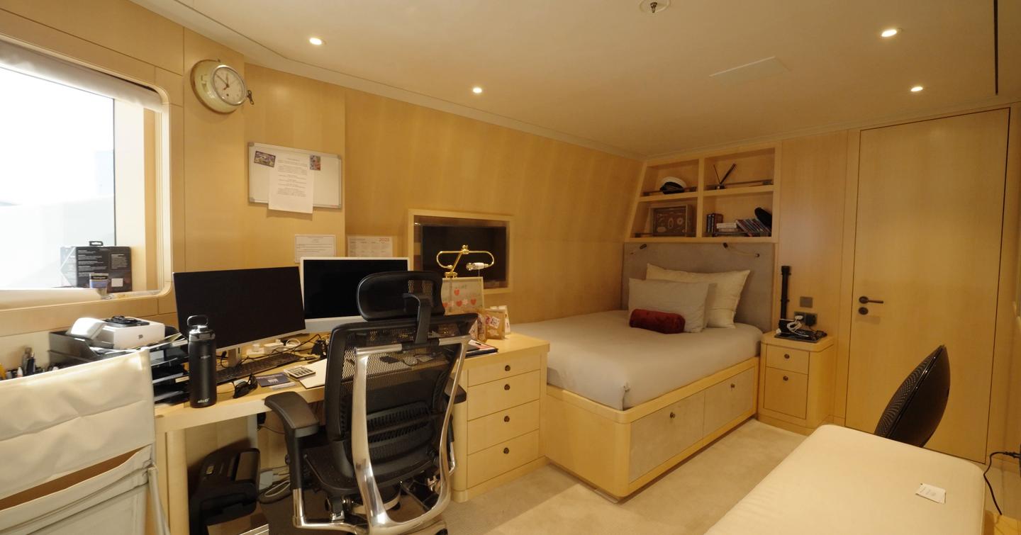 Captain’s cabin located just aft of the bridge on the Amels 242 Casino Royale with desk workspace and single berth.