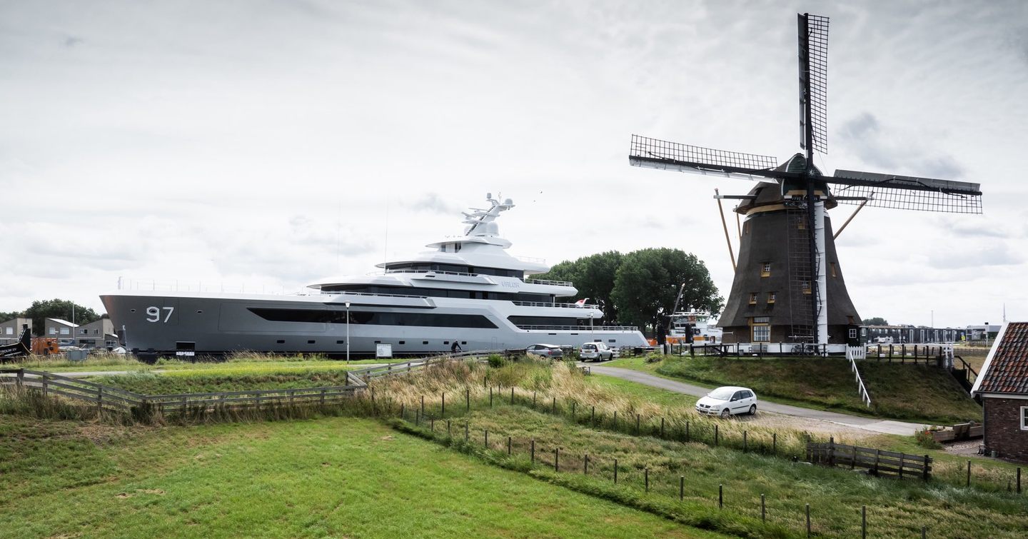 Feadship 80m Explorer Yacht Valor in Dutch canals next to windmill 