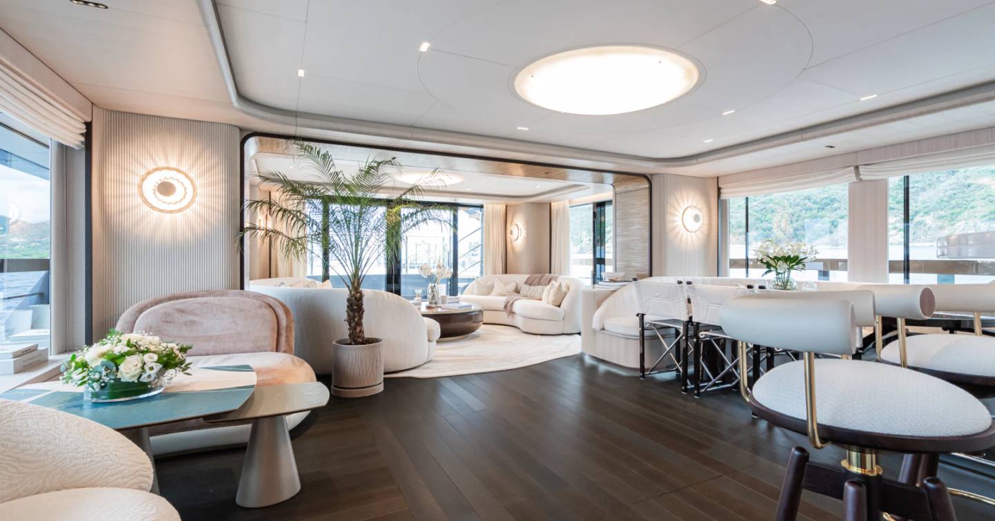 Expedition yacht M's main saloon with cream furniture and bar area