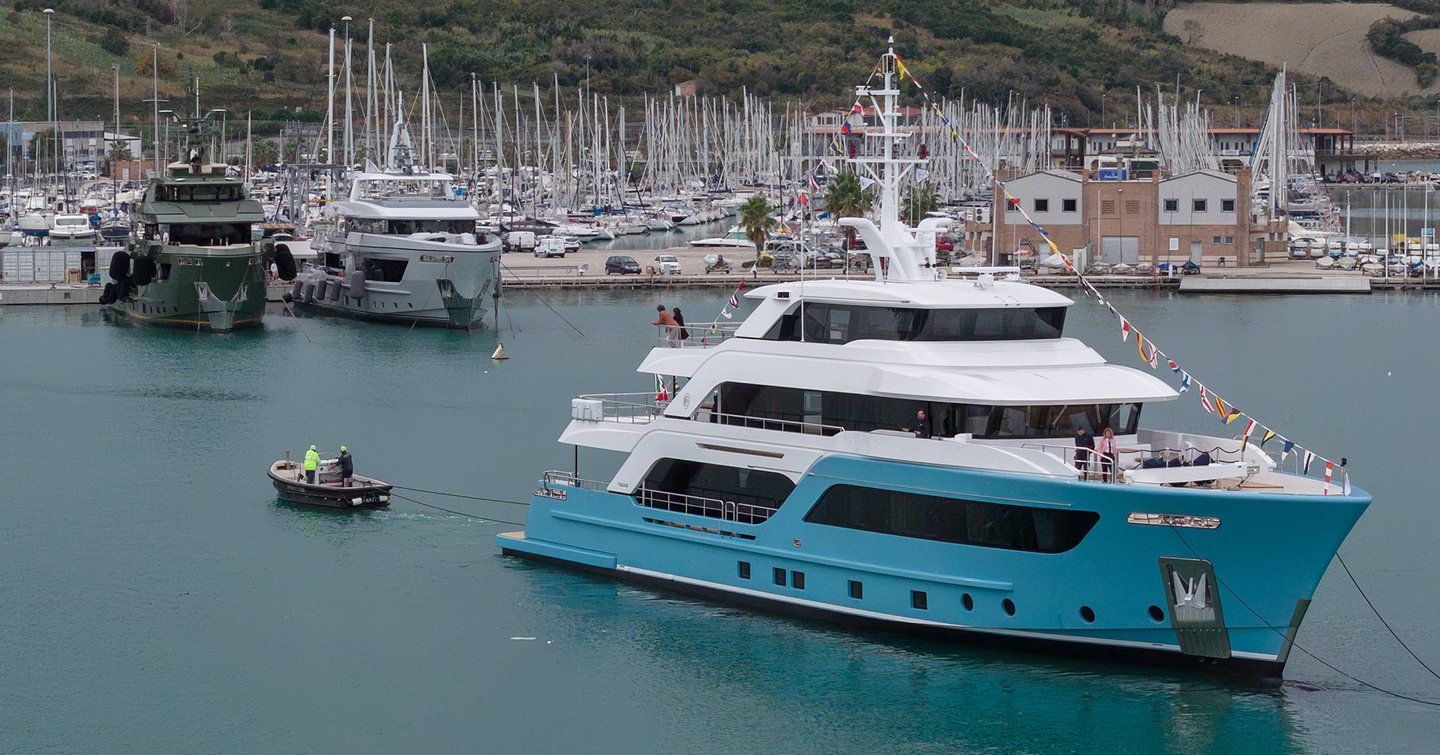 Explorer Yacht Presence at launch in harbour in front of tugboat