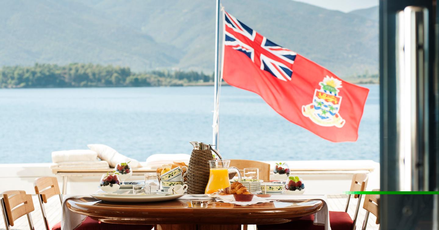 red ensign on aft deck with table laid for breakfast