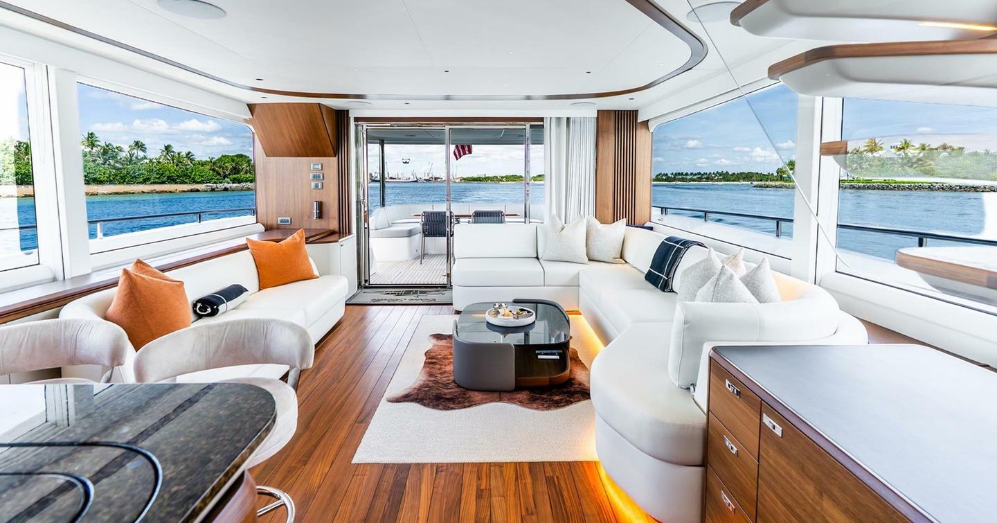Motor Yacht Cosa Bella main saloon with curved white sofa 