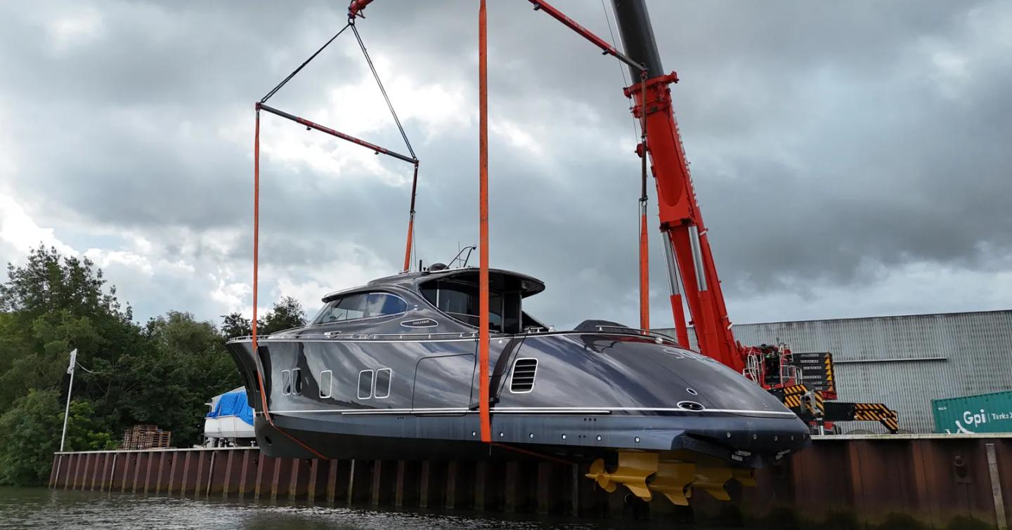 Zeelander 8 Motor Yacht Solea being lowered into water on orange cradle 