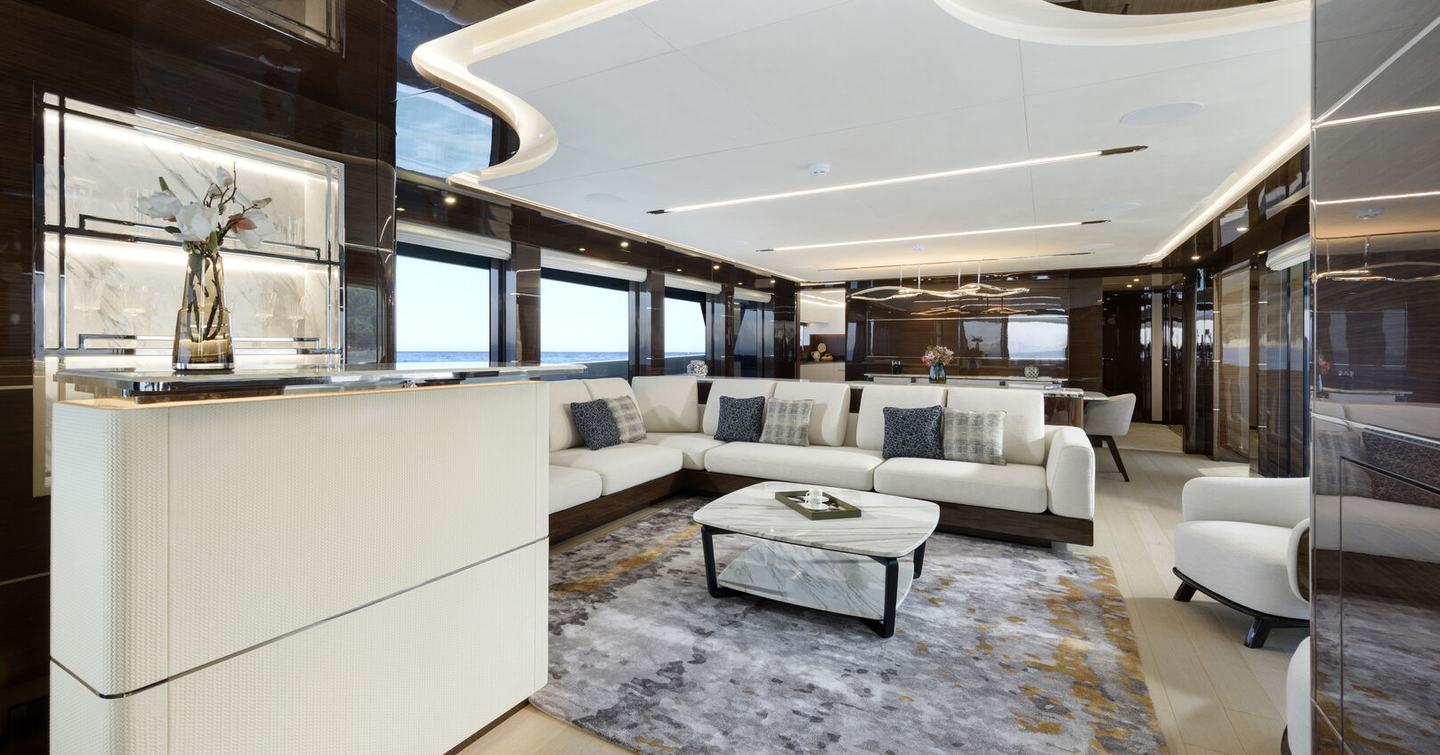 Lazzara UHV 100 Motor Yacht main salon with white sofa and marbled table